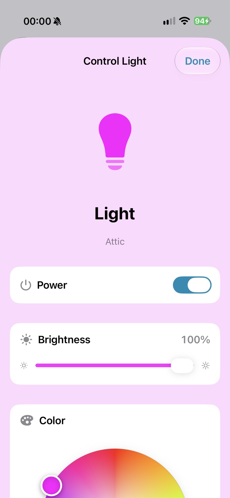 The light control screen for a lamp in the attic. A magenta lamp symbol on top, then switches for power and brightness at 100 percent, and a colour wheel.